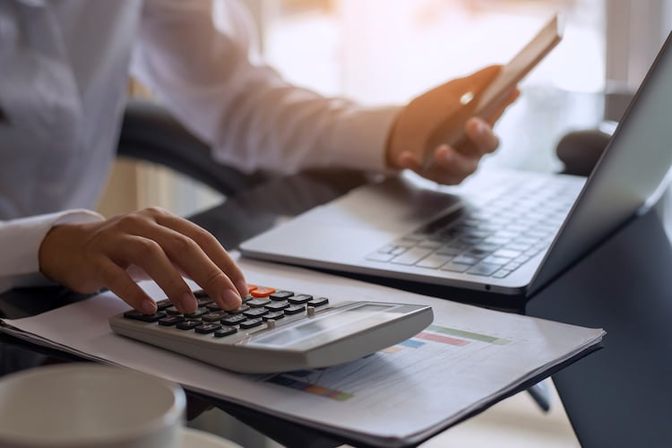 business woman using calculator