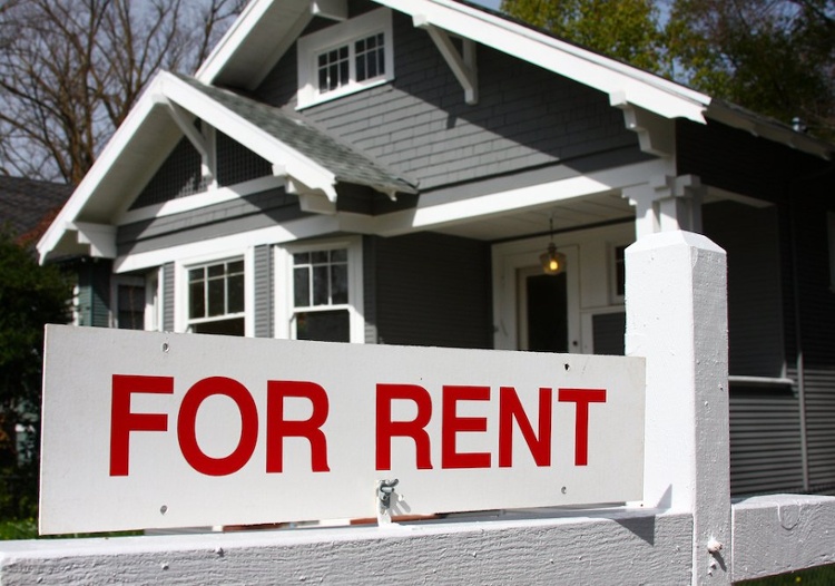 for rent sign in front of small gray house-1