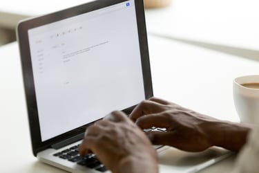 man writing on computer