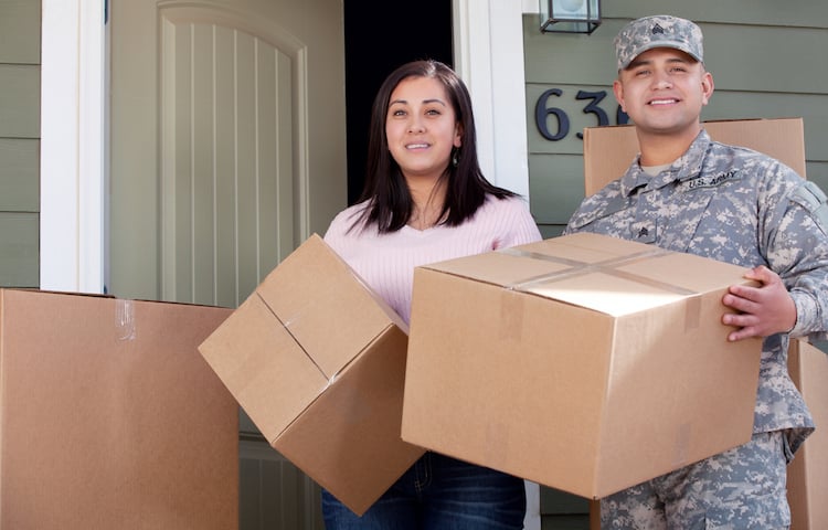 military couple moving boxes