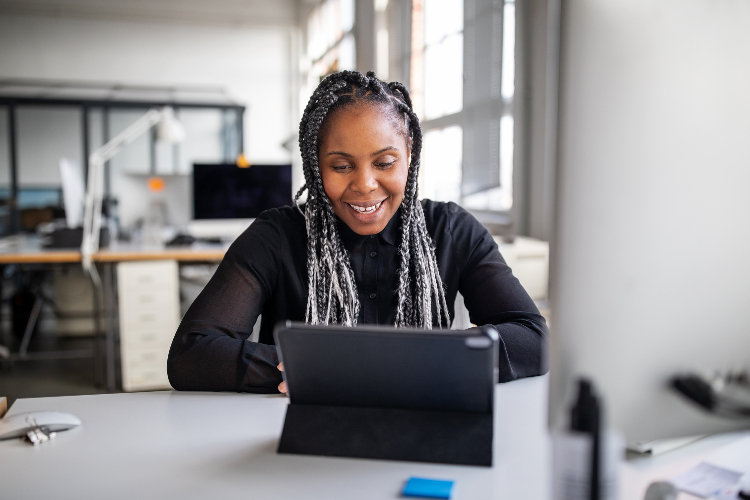 woman smiling at laptop computer